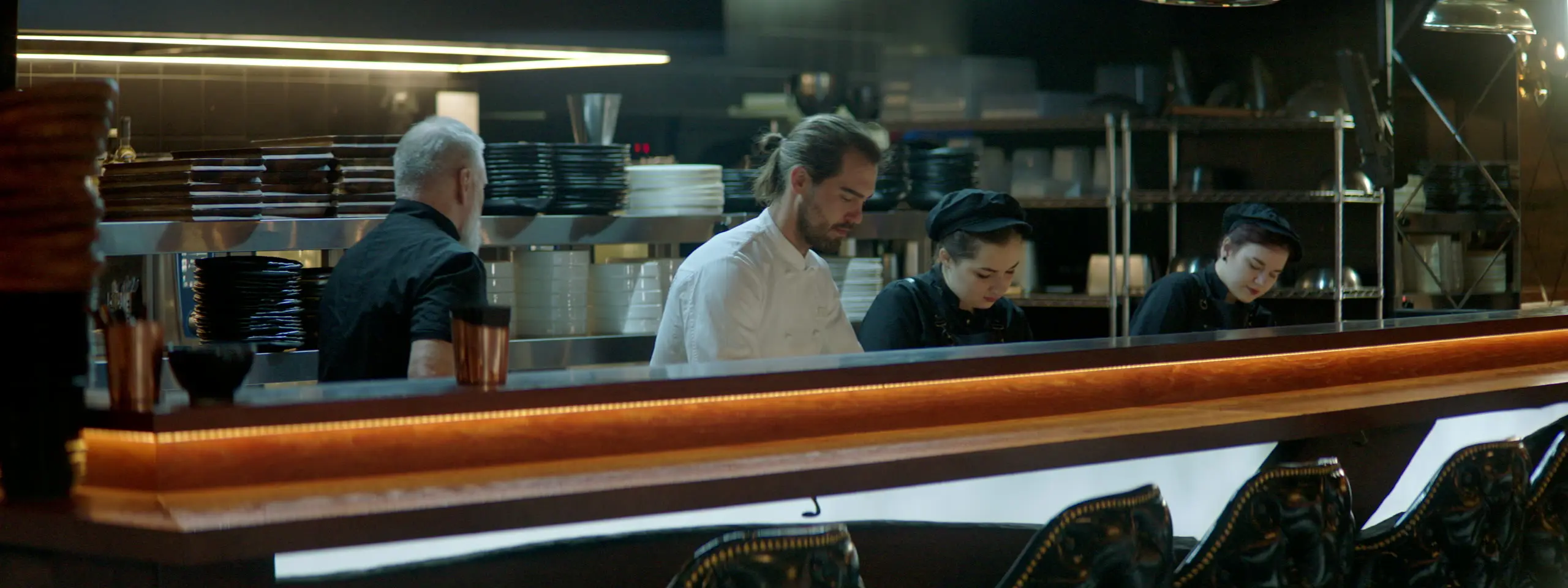 A kitchen team plating up at the pass